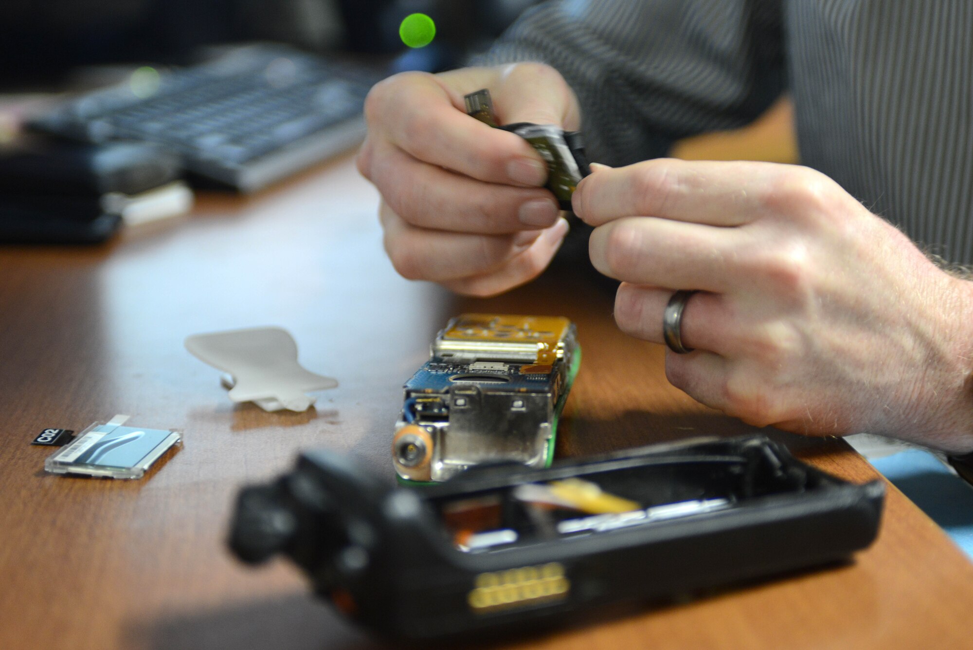 Andrew M. Vande Hei, 366th Communications Squadron personal wireless communications system manager, repairs a land mobile radio by replacing the display module, Jan. 9, 2014, at Mountain Home Air Force Base, Idaho. The Communications Focal Point consists of 13 technicians, serving 3,900 customers and resolving about 200 requests monthly across MHAFB. (U.S. Air Force photo by Senior Airman Caitlin Guinazu/Released)