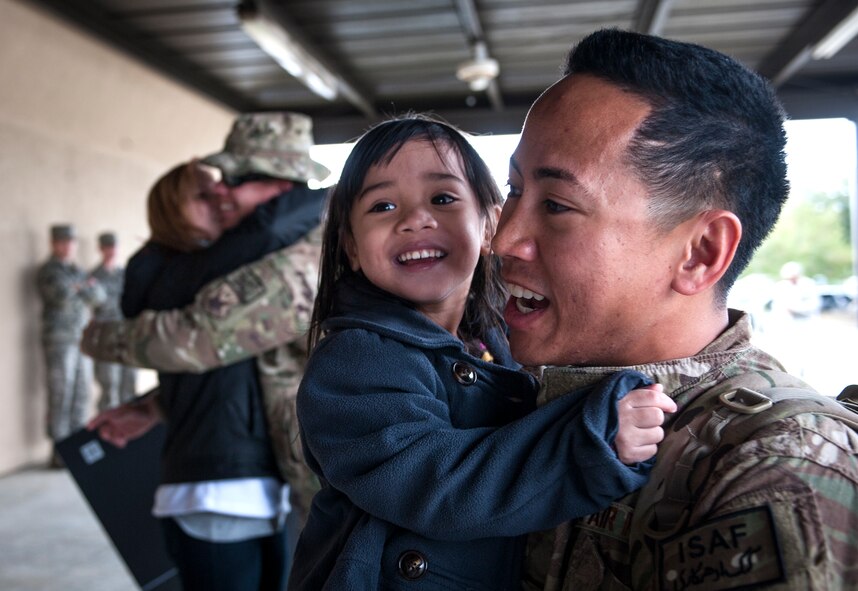 U.S. Air Force 2nd Lt. Marques Reyes holds his daughter during a deployment return at Moody Air Force Base, Ga., Jan. 9, 2014. Reyes was deployed as part of the 26th Expeditionary Rescue Squadron, which is credited with 2,400 lives saved and more than 3,300 assists in the last 59 months. (U.S. Air Force photo by Senior Airman Jarrod Grammel/Released)
