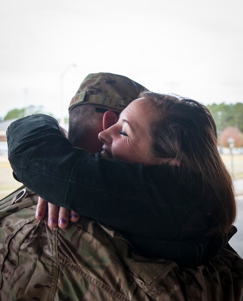 Cameron D’Aquila hugs her husband, U.S. Air Force Senior Airman Salvatore D’Aquila during a deployment return at Moody Air Force Base, Ga., Jan. 9, 2014. D’Aquila and other Airmen with the 26th Expeditionary Rescue Squadron returned to Moody 90 days into a deployment to Camp Bastion, Afghanistan, after the 26th ERQS was deactivated Jan. 1, 2014. (U.S. Air Force photo by Senior Airman Jarrod Grammel/Released)
