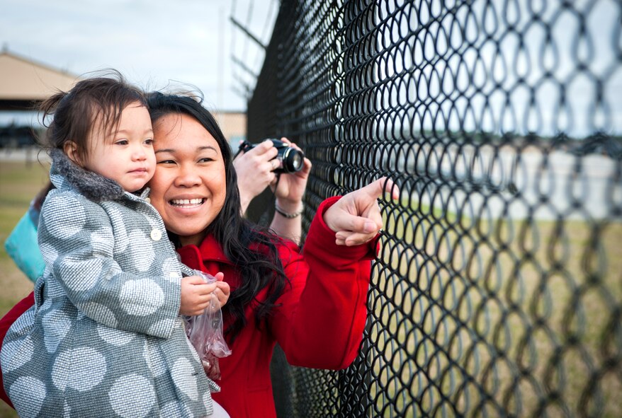 Crysty Graves, wife of U.S. Air Force Tech. Sgt. Mark Graves, and daughter Kallie Graves, wait for their loved one to return from a deployment at Moody Air Force Base, Ga., Jan. 9, 2014. Graves was a maintainer with 26th Expeditionary Rescue Squadron until its deactivation Jan. 1, 2014. (U.S. Air Force photo by Senior Airman Jarrod Grammel/Released) 


