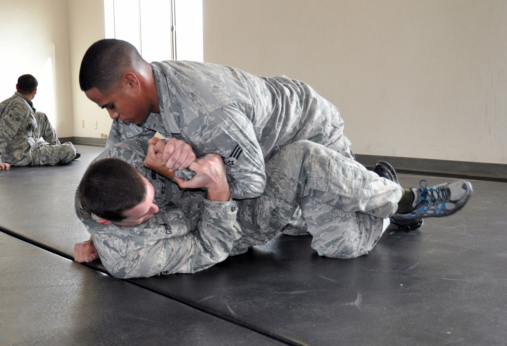 TRAVIS AIR FORCE BASE, Calif. -- Senior Airman Lucas Gibson, 349th Security Forces Squadron, officer, grapples with Senior Airman Alex Bombita, 349th SFS, officer as they practice defensive combative moves on Jan. 4, 2014. (U.S. Air Force photo/Senior Airman Cindy G. Alejandrez)