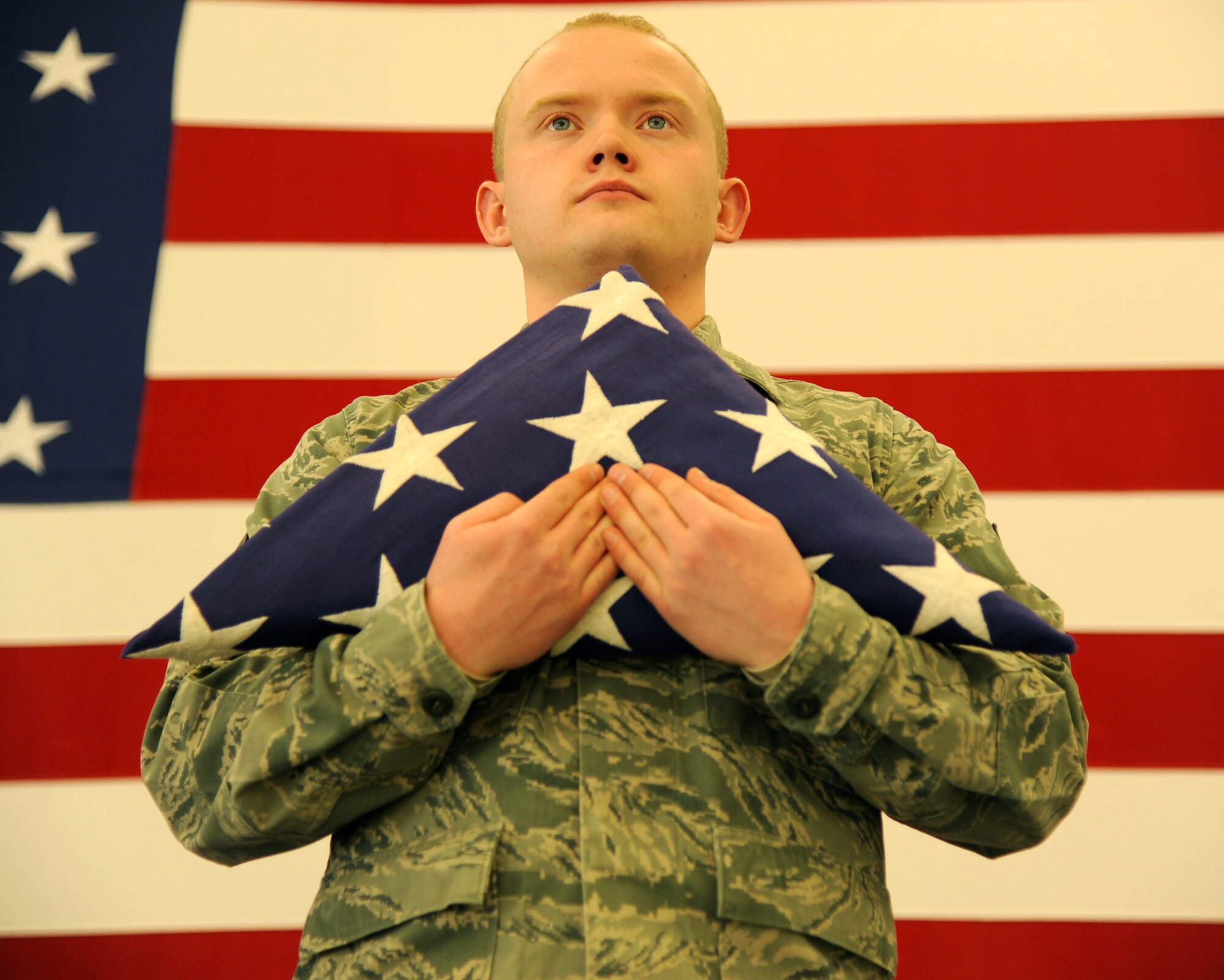 Senior Airman Scott Phillips, 319th Air Base Wing Honor Guard ceremonial guardsman, holds the American flag while practicing one of the various ceremonies Honor Guard performs, Jan. 8, 2014, on Grand Forks Air Force Base, N.D. The Hanover, Minn., native was named the Warrior of the Week for the first week of January 2014. (U.S. Air Force photo/Airman 1st Class Zachiah Roberson)