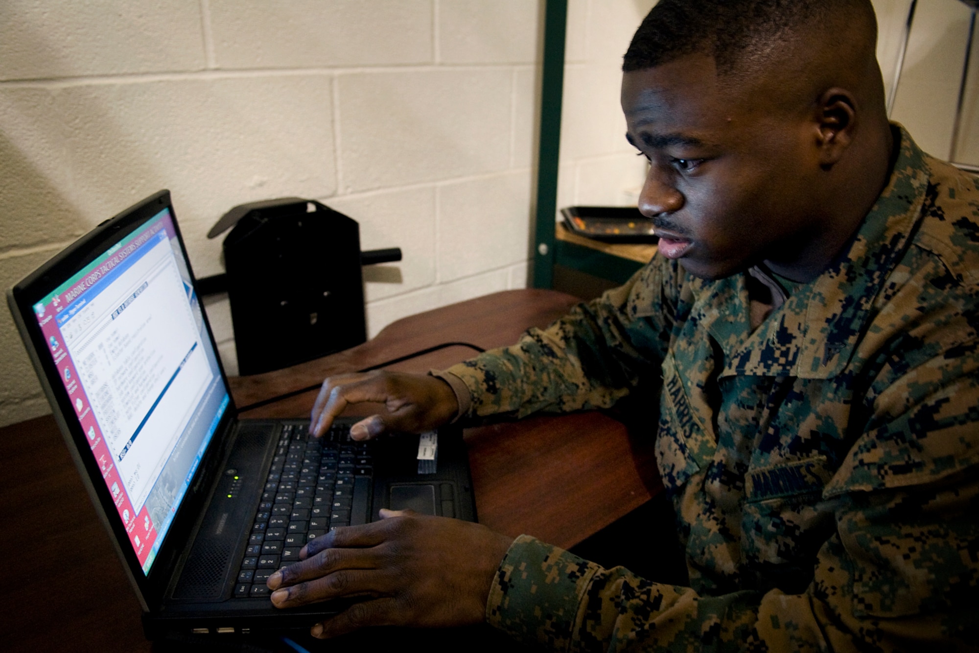 Lance Cpl. Corey Harris, a tactical switching operator with Detachment One, Communication Company, Combat Logistics Regiment 45, 4th Marine Logistics Group, works on communications equipment during an exercise held at Grissom Air Reserve Base, Ind., Dec. 7. During the two-day exercise, Grissom Marines worked 24-hours-a-day to establish radio and data contact with fellow Marines in Greensboro, N.C. (U.S. Air Force photo/Tech. Sgt. Mark R. W. Orders-Woempner)
