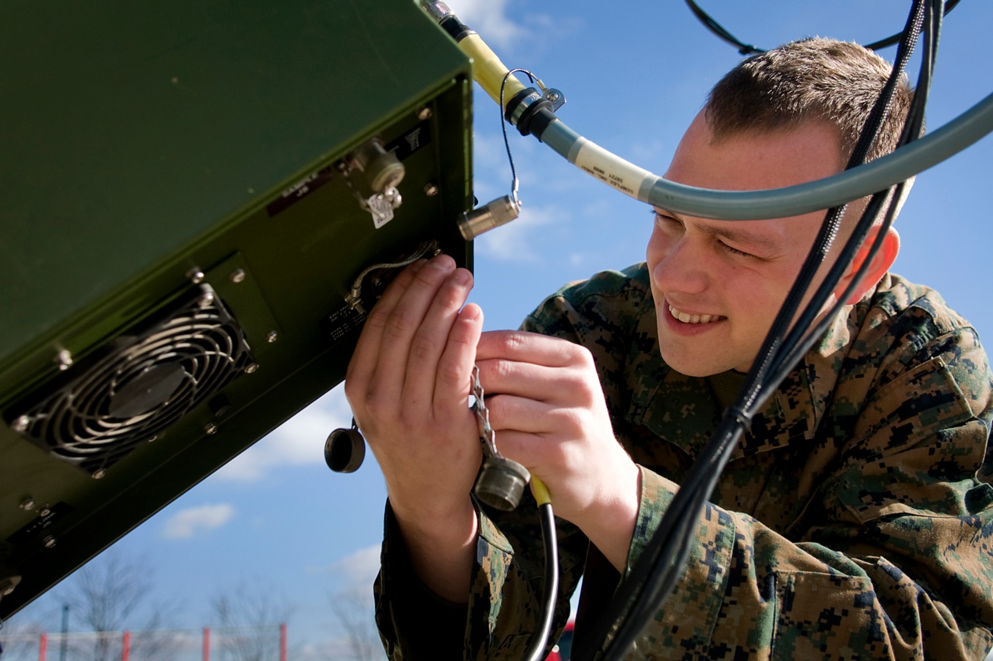 Cpl. Brian Castille, a cyber network operator with Detachment One, Communication Company, Combat Logistics Regiment 45, 4th Marine Logistics Group, works on a satellite communications system during a communications exercise at Grissom Air Reserve Base, Ind., Dec. 7, 2013. During the two-day exercise, Marines worked 24-hours-a-day to establish radio and data contact with fellow Marines in Greensboro, N.C. (U.S. Air Force photo/Tech. Sgt. Mark R. W. Orders-Woempner) 
