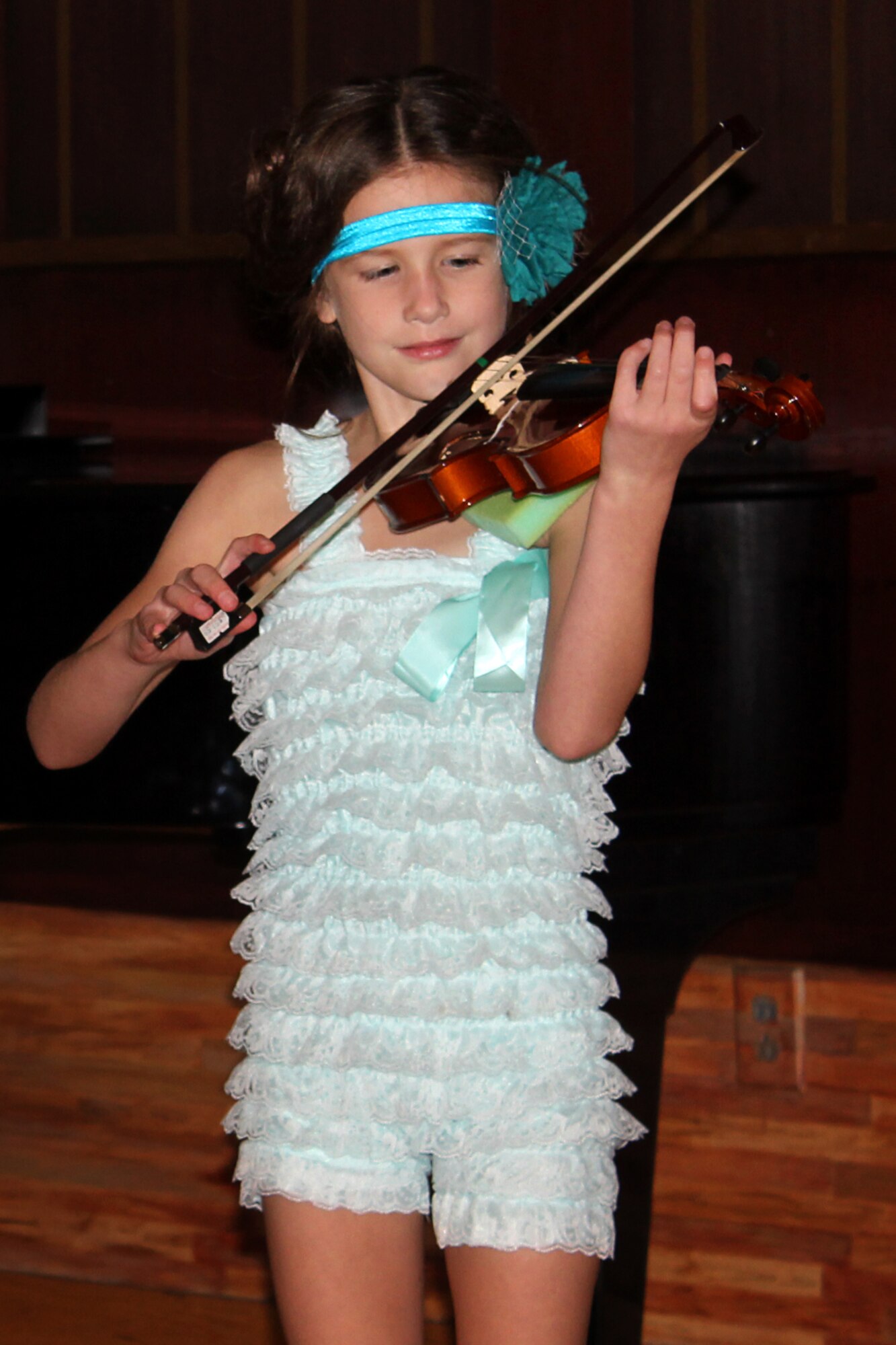 Melea Morgan, daughter of Master Sgt. Michael Morgan, 72nd Air Refueling Squadron inflight refueling evaluator, and Tech. Sgt. Erica Morgan, 434th Aircraft Maintenance Squadron personnel specialist, plays violin during a recital in Indianapolis Oct. 27, 2013. Master Sergeant Morgan was able to witness his daughter's recital through modern video messaging while he was deployed to Southwest Asia. (U.S. Air Force photo/Tech. Sgt. Erica Morgan)
