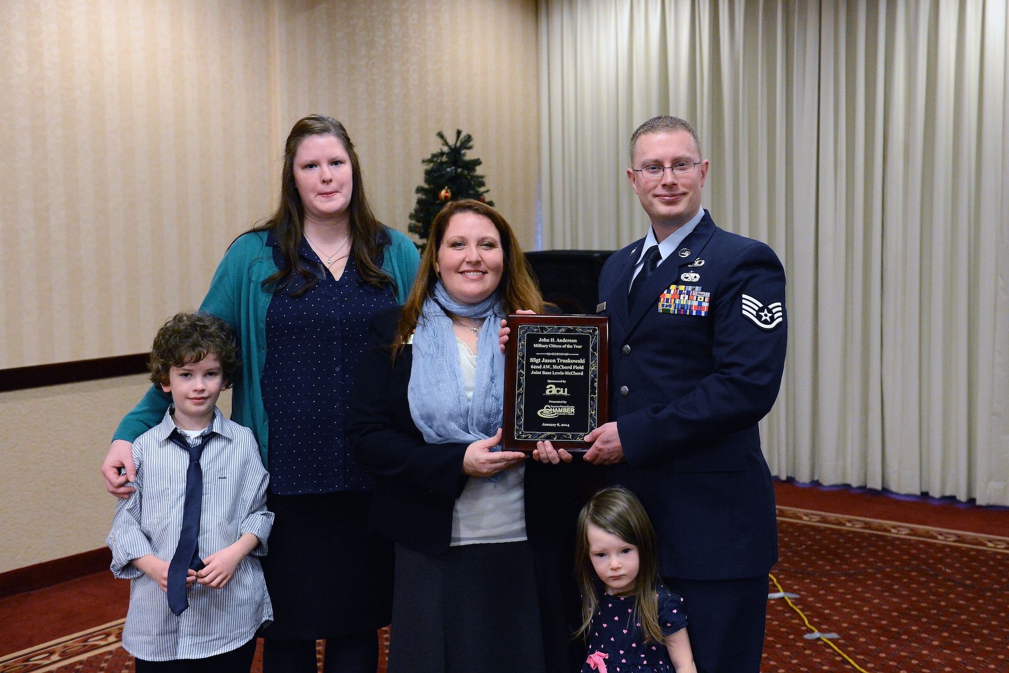 Staff Sgt. Jason Truskowski, 62nd Airlift Wing NCO in charge of Public Affairs operations, is presented with the 35th Annual John H. Anderson Military Citizen of the Year Award Jan. 8, 2014 at Tacoma-Pierce County Chamber’s Military Affairs Committee meeting in Tacoma, Wash. Truskowski was presented the award for demonstrating numerous contributions to the local community through community service and community outreach. (U.S. Air Force photo/Airman 1st Class Jacob Jimenez) 