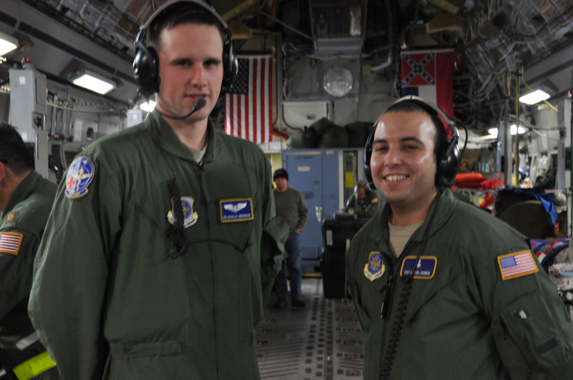 Senior Airman Nicholas Andermahr, 349th Aeromedical Evacuation Squadron aeromedical evacuation technician and Staff Sgt. Gabriel Hannen, 349th Aeromedical Staging Squadron cardiopulmonary technician, take a photo at 36,000 ft. during a medical evacuation flight over the Atlantic Ocean en route to Andrews Air Force Base. "I love you Amanda, Merry Christmas Mamy, Frank, Dimitri, Elisha, Kiki, Manny, Tio Gustavo, Mama y Papa," said Hannen. "To my family, I love you and miss you guys, Merry Christmas," said Andermahr.(U.S. Air Force photo/Staff Sgt. Christopher Carranza)