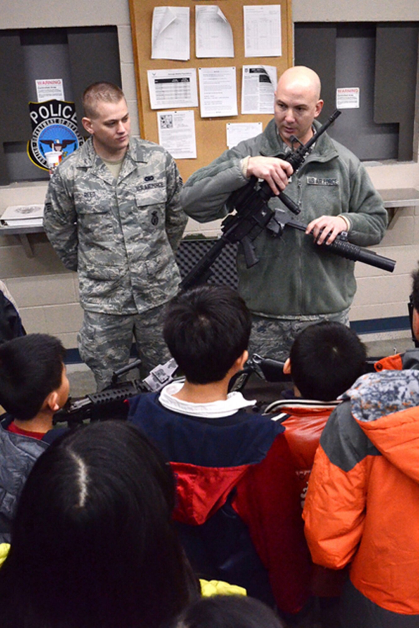 Members of the 94th Security Forces Squadron demonstrate various weapons and night-vision equipment items to members of the North Atlanta Chinese Baptist Church during a base tour Jan. 6. (U.S. Air Force photo/Brad Fallin)