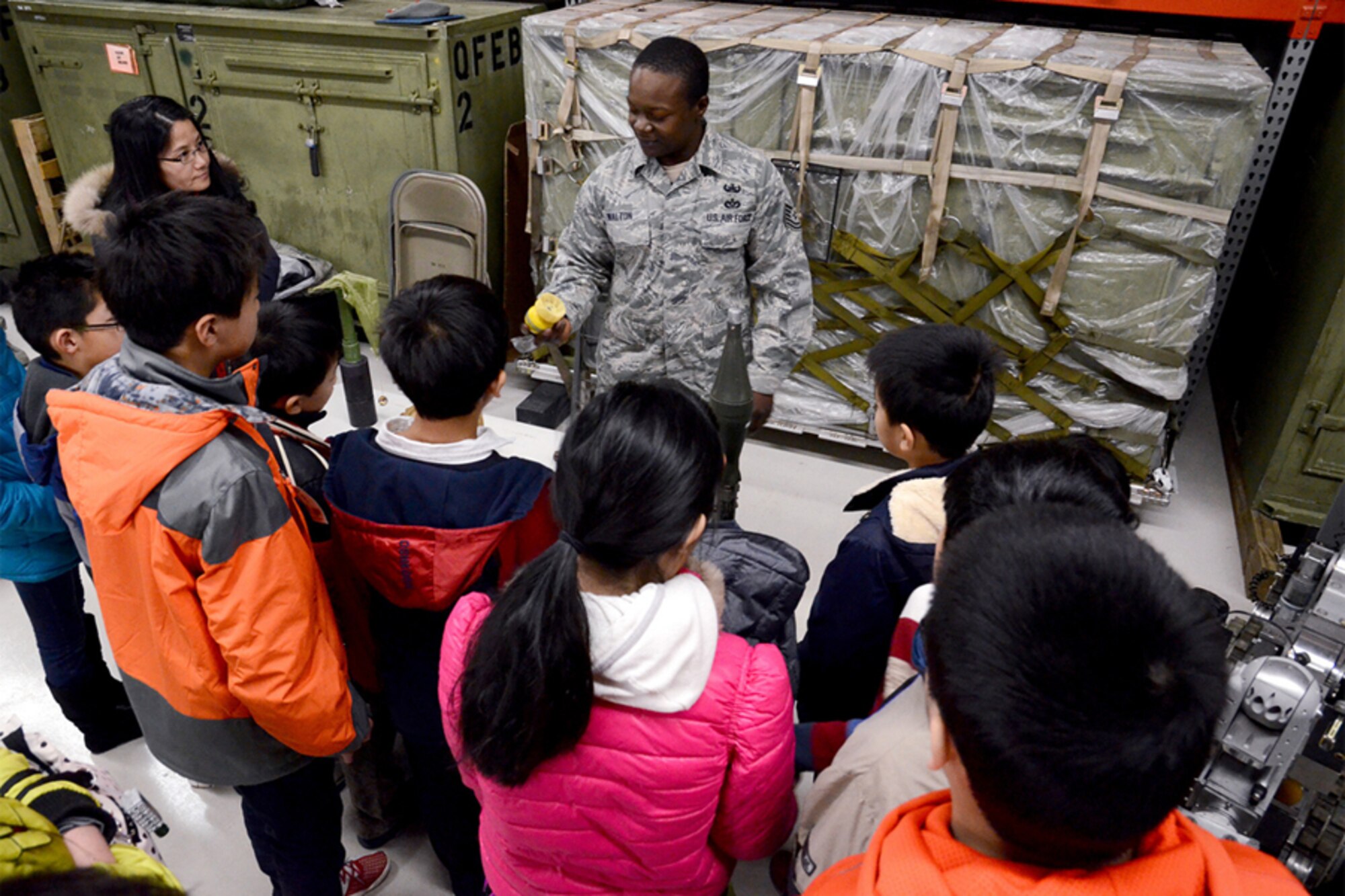 Tech. Sgt. George Walton of the 94th Explosive Ordnance Disposal Flight displays ordnance disposal equipment and a detonation robot to members of the North Atlanta Chinese Baptist Church during a base tour Jan. 6. (U.S. Air Force photo/Brad Fallin)
