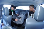 Connie Miller (left), 359th Medical Operations Squadron social services assistant, demonstrates secure car seat installation at Joint Base San Antonio-Randolph. The first monthly Car Seat 101 class is scheduled for Jan. 22, 10 a.m. to noon at the JBSA-Randolph Health and Wellness Center. (U.S. Air Force photo by Rich McFadden)