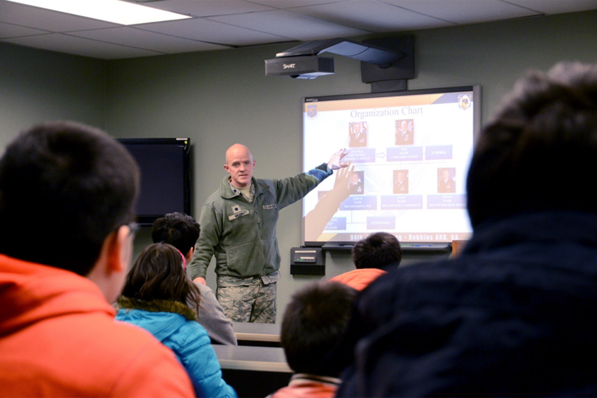 Lt. Col. James Wilson, chief of Public Affairs, gives an overview of the 94th Airlift Winging mission to members of the North Atlanta Chinese Baptist Church during a base tour Jan. 6. (U.S. Air Force photo/Brad Fallin)