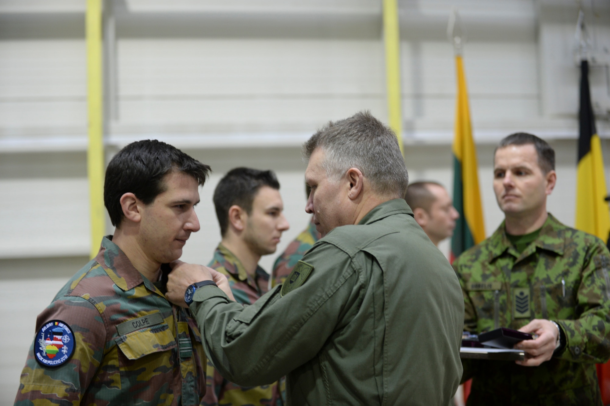 Maj Gen Edvardas Mažeikis, commander of the Lithuanian Air Force, presents Belgian air force members the Common award during a Change of Command ceremony at Šiauliai Air Base, Lithuania, Jan. 3, 2014. The ceremony acknowledged the transfer of the Baltic Air Policing mission from the Belgian air force to the U.S. Air Force. The U.S. will maintain Lithuania’s sovereign air space for a period of four months. (U.S. Air Force photo by Airman 1st Class Nigel Sandridge/Released)