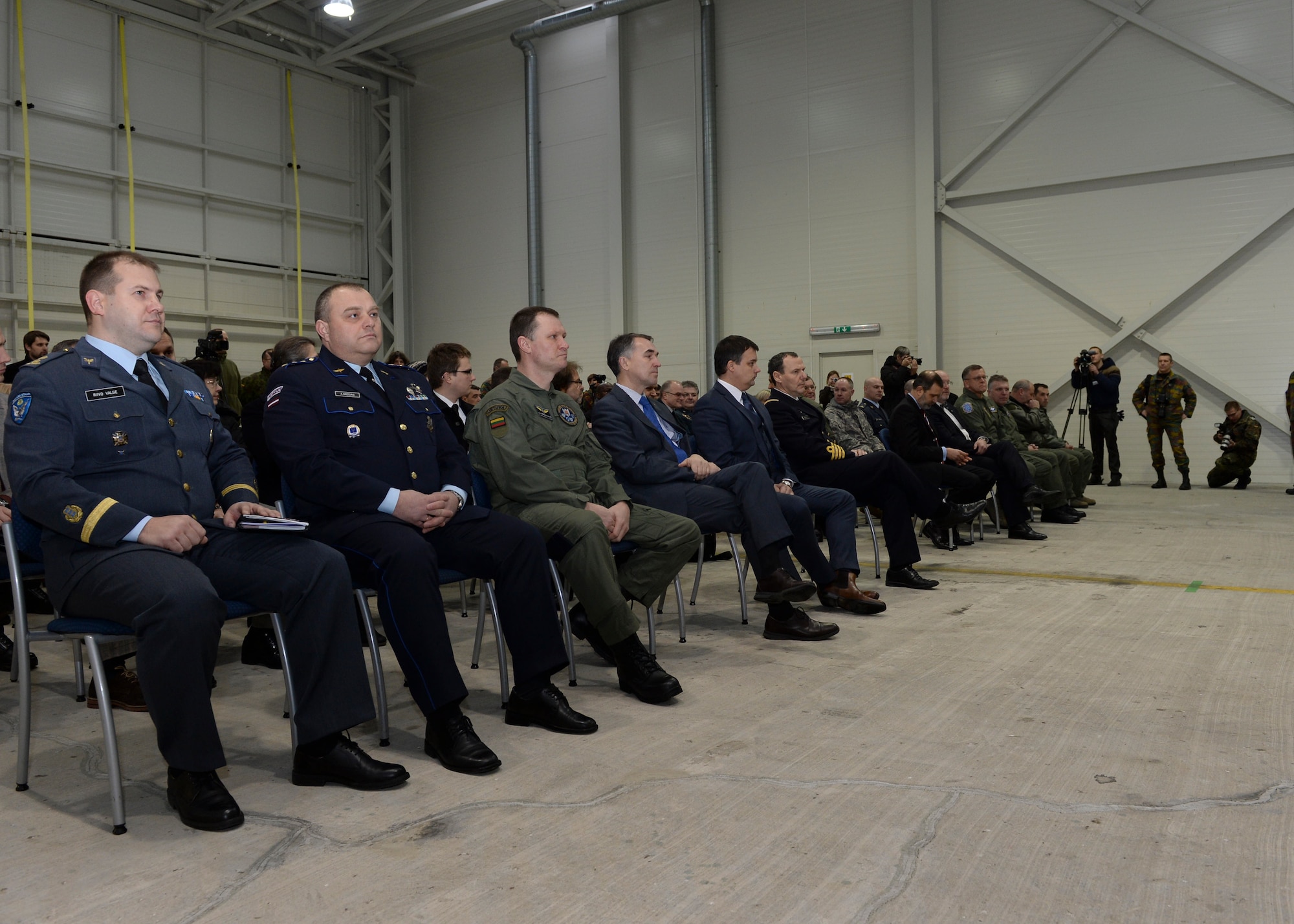 Spectators watch as the U.S. Air Force takes control of the Baltic Air Policing mission during a change of command at Šiauliai Air Base, Lithuania, Jan. 3, 2014. The ceremony acknowledged the mission transfer from the Belgian air force to the U.S. Air Force. The U.S. will maintain Lithuania’s sovereign air space for four months. (U.S. Air Force photo by Airman 1st Class Nigel Sandridge/Released)