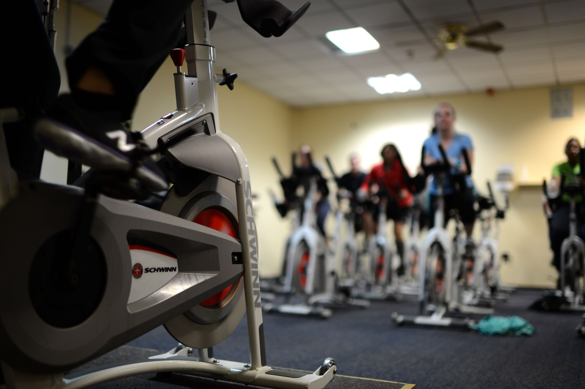 SPANGDAHLEM AIR BASE, Germany – Members of the Spangdahlem community attend a spin class inside the Skelton Memorial Fitness Center Jan. 7, 2014. Volunteers will move the spin bike equipment to the new fitness center starting Jan. 10, 2014. The equipment will be available after the grand opening of the new fitness center Jan. 13, 2014. (U.S. Air Force photo by Senior Airman Gustavo Castillo/Released)