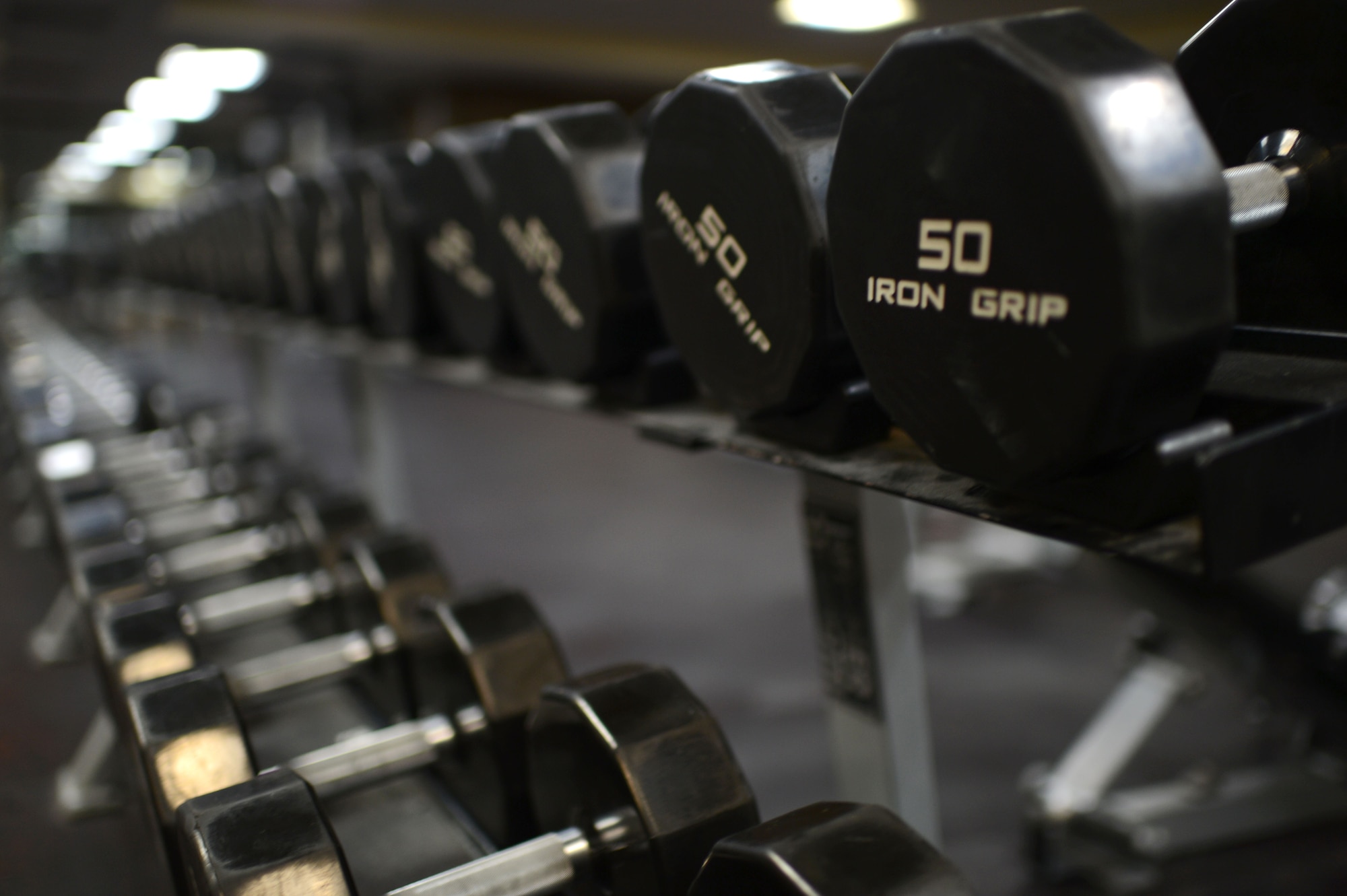 SPANGDAHLEM AIR BASE, Germany – Dumbbell weights rest on a weight rack inside the Skelton Memorial Fitness Center Jan. 7, 2014. The weight room will close Jan. 9, 2014, as part of the movement of equipment in to the new Fitness Center. (U.S. Air Force photo by Senior Airman Gustavo Castillo/Released