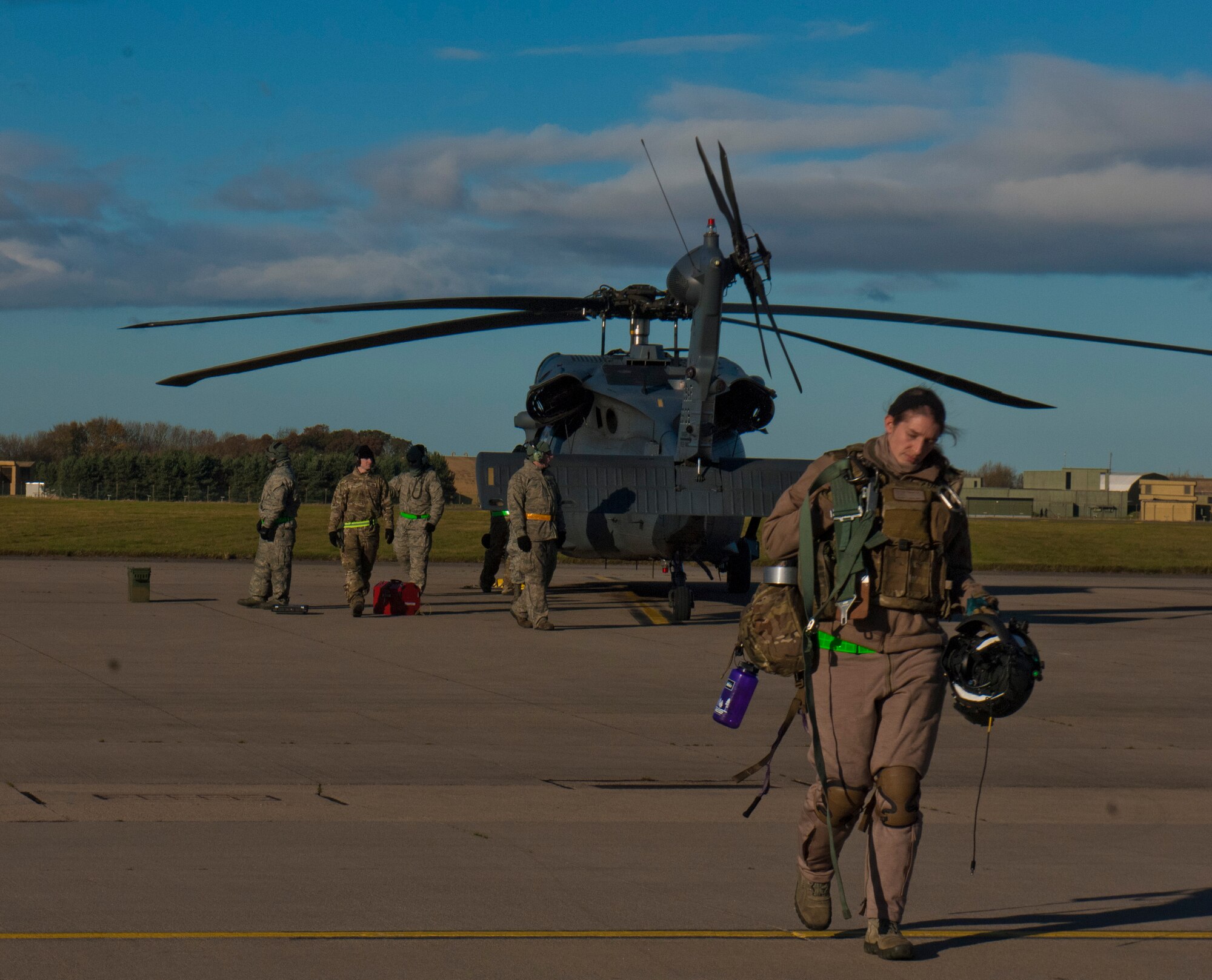 Staff Sgt. Afton Ponce, 56th Rescue Squadron special mission aviator, steps away from an HH-60G Pave Hawk just after landing Nov. 19, 2013, at Royal Air Force Leeming, England. The 56th RQS flew to the RAF Spadeadam test range, where they had the opportunity to hone their skills engaging real ground threats and air defenses. The exercise took place Nov. 18-22, and involved both the 56th RQS and 748th Aircraft Maintenance Squadron. (U.S. Air Force photo by 2nd Lt. Keenan Kunst/Released)
