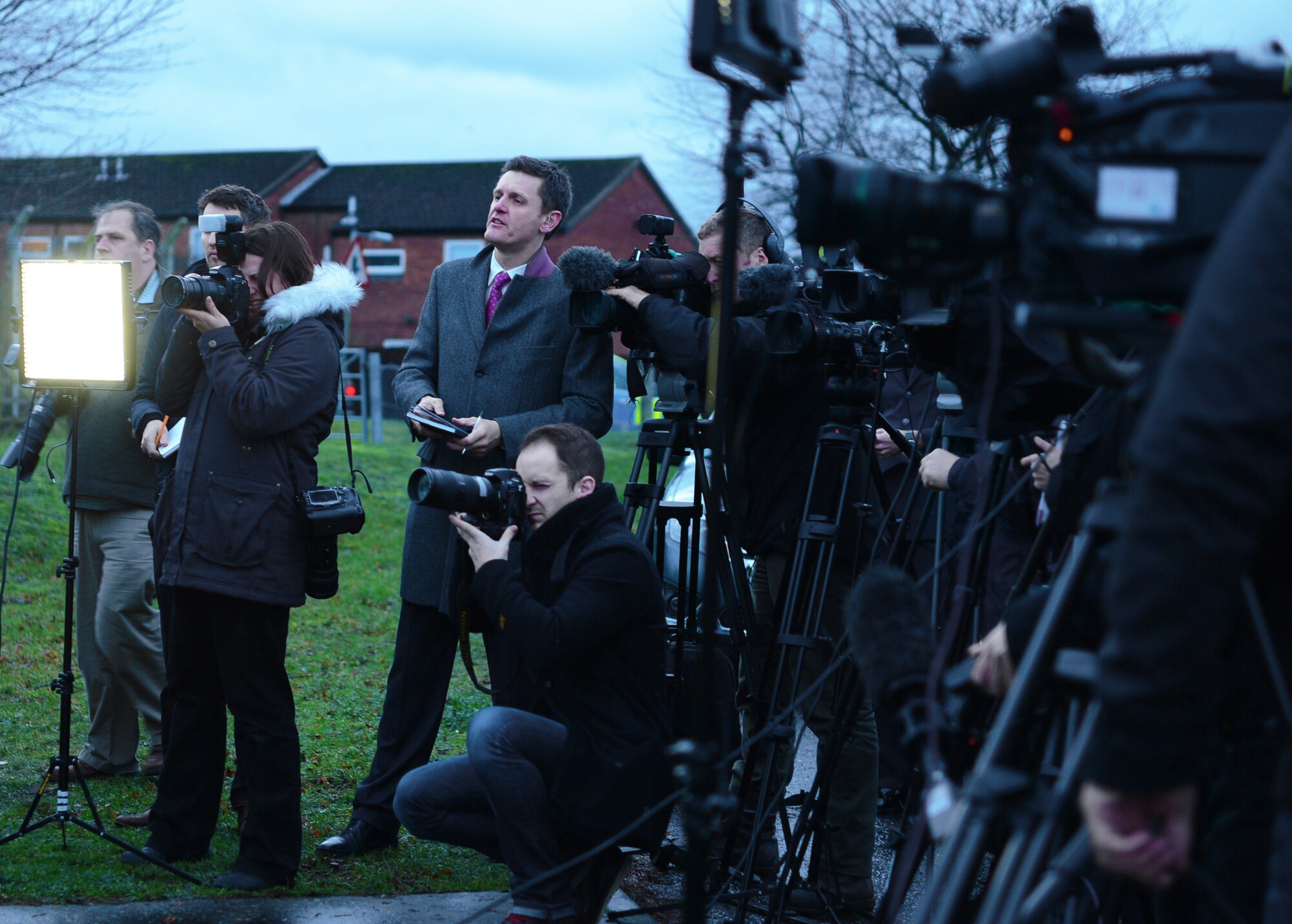 Media outlets ask Col. Kyle Robinson, 48th Fighter Wing commander, questions during a press conference Jan. 9, 2014 at Royal Air Force Lakenheath, England. The press conference was held to address the tragedy of the HH-60 Pave Hawk helicopter crash, Tuesday, Jan. 7, 2014. (U.S. Air Force photo by Airman 1st Class Dawn M. Weber)