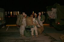 Marines and sailors with Combat Logistics Battalion 24, Combat Logistics Regiment 27, 2nd Marine Logistics Group load their packs onto the back of a Medium Tactical Vehicle Replacement prior to departing Camp Lejeune, N.C., Jan. 10, 2013. More than 180 service members with the battalion left to attend the Integrated Training Exercise aboard Twentynine Palms, Calif. to maintain mission readiness.   (U.S. Marine Corps photo by Lance Cpl. Shawn Valosin)