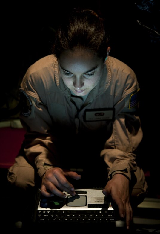 Senior Airman Jamie Young, 86th Aircraft Maintenance Squadron crew chief, looks through the diagnostics of a C-130J to ensure it is working properly Dec. 18 on Sigonella Naval Air Station, Italy. Airmen of the 37th Airlift Squadron, assigned to Ramstein Air Base, Germany, delivered much-needed supplies and personnel to Central African Republic, Africa, in order to help stabilize the region after recent conflicts. (U.S. Air Force photo/Senior Airman Damon Kasberg)