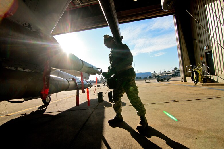 U.S. Air Force Airman 1st Class Desmond Charles from the New Jersey Air National Guard's 177th Fighter Wing disassembles a GBU-12 Paveway II mounted on an F-16C Fighting Falcon during the annual load crew competition on Jan. 9 at Atlantic City Air National Guard Base, N.J.  Charles is an aircraft armament systems specialist assigned to the 177th Aircraft Maintenance Squadron.  (U.S. Air National Guard photo by Tech. Sgt. Matt Hecht/Released)