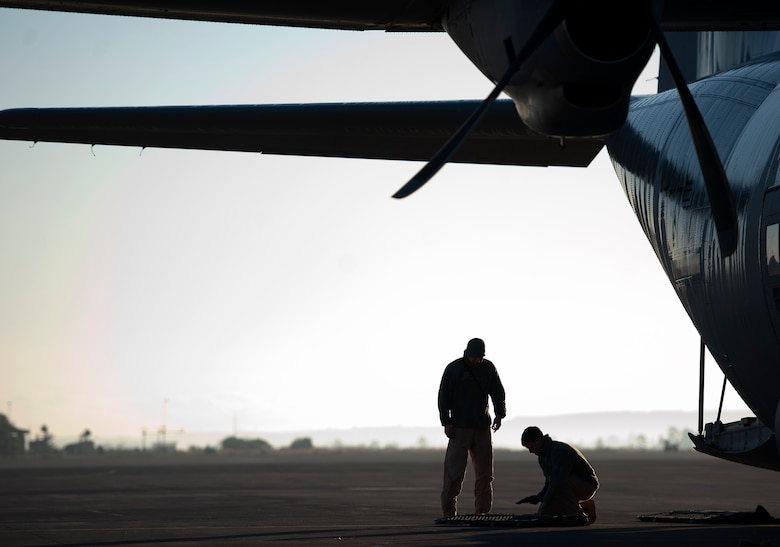 Airman 1st Class Andrew Bracamontes (left) and Senior Airman Matthew Howard (right), Ramstein Fly Away Security Team members, assigned to Ramstein Air Base, Germany, double check equipment prior to boarding a C-130J Super Hercules, Dec. 18 on Sigonella Naval Air Station, Italy. FAST members provided security for the Airmen of the 37th Airlift Squadron during a mission to Central African Republic, Africa, delivering much-needed supplies and personnel as part of a peace-keeping mission providing support to the civilian population disrupted by the nation’s recent conflicts. (U.S. Air Force photo/Senior Airman Damon Kasberg)