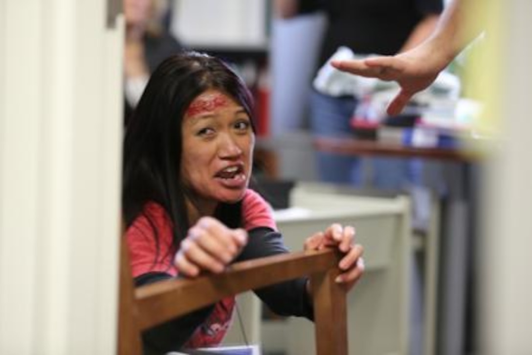 A base employee from Marine Corps Logistics Base Barstow, Calif., acts as a victim for an active shooter training exercise on base, Dec. 18. Emergency services here were evaluated on how they handled the victims in distress and evacuated survivors.


