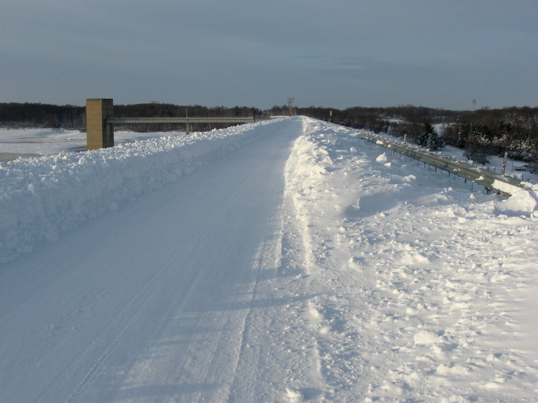 Snow covers a two-lane road atop the dam at Mississinewa Lake. After the winter storm, which brought snow, extreme cold and dangerous wind conditions, a state of disaster was declared for 29 of Indiana's 92 counties.