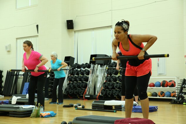 Lisa Jones, a retired soldier, does triceps extensions during a Strictly Strength class at Barber Physical Activity Center on Jan. 6, 2013. This hour-long class is a total body workout offered by Marine Corps Community Services.