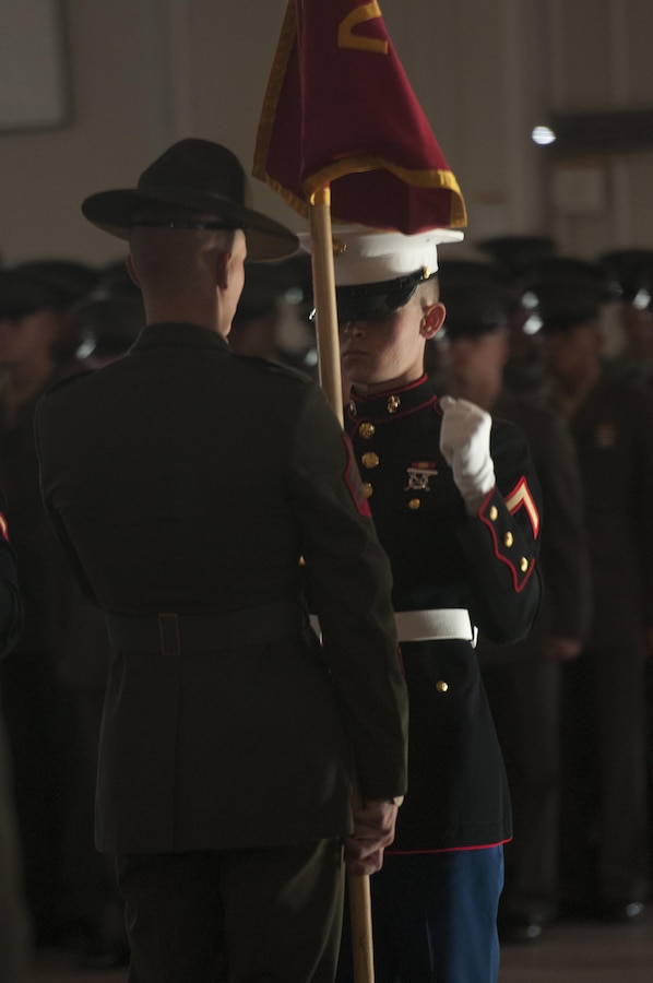 PARRIS ISLAND - S.C. - Pfc. Harry C. Meadows, honor graduate for platoon 2001, returns the guidon to his drill instructor during a graduation ceremony here, Jan. 10, 2013. Meadows, a native of Auburn, Ala., was recruited by Staff Sgt. Byron J. Bacon, a recruiter from Permanent Contact Station Auburn, Recruiting Station Montgomery. Meadows will be able to enjoy some much deserved leave with his family as he prepares for Marine combat training in Camp Geiger, N.C. (U.S. Marine Corps photo by Lance Cpl. Stanley Cao/released)