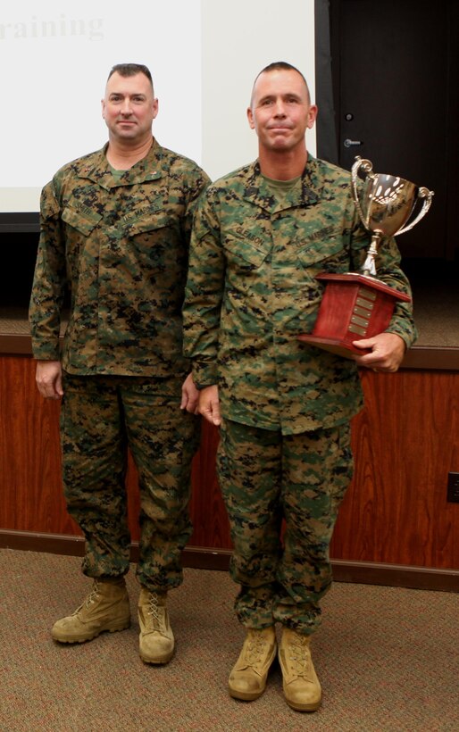 Chief Warrant Officer 3 Michael J. Smith (Left), band officer, U.S. Marine Corps Forces, Pacific Band, and Master Gunnery Sgt. Mark D. Gleason, bandmaster, stand with the 2013 Marine Corps Band of the Year Award. The MarForPac Band received the award for the first time.