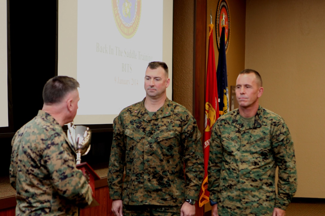 Lt. Gen. Terry G. Robling, commander, U.S. Marine Corps Forces, Pacific, presents the trophy for the Marine Corps Band of the Year Award to Chief Warrant Officer 3 Michael J. Smith, band officer, MarForPac Band, and Master Gunnery Sgt. Mark D. Gleason, bandmaster. The award is given to the best of the 10 field bands in the Marine Corps.