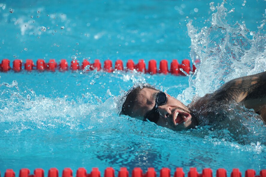Staff. Sgt. August O’niell, Air Force Wounded Warrior, competes in a swim meet during the inaugural Wounded Warrior Pacific Invitational in Honolulu, Hawaii, Jan. 9, 2014. O’niell was struck by enemy small arms fire in the left knee and right calf July 2011 while deployed to Southeast Asia July 2011. The WWPI will pit more than 120 warriors against each other in cycling, seated volleyball, swimming, wheelchair basketball and track and field. (U.S. Air Force photo/Master Sgt. Matthew McGovern)
