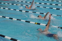 Air Force wounded warriors compete in a back-stroke event during the inaugural Wounded Warrior Pacific Invitational in Honolulu, Hawaii, Jan. 9, 2014.   The race is part of the adaptive athletic reconditioning program which helps wounded warriors build strength and endurance, while they draw inspiration from their teammates. All enrollees in Air Force Wounded Warriors program are encouraged to make athletics an essential part of their recovery, rehabilitation and rehabilitation plans. (U.S. Air Force photo/Master Sgt. Matthew McGovern)