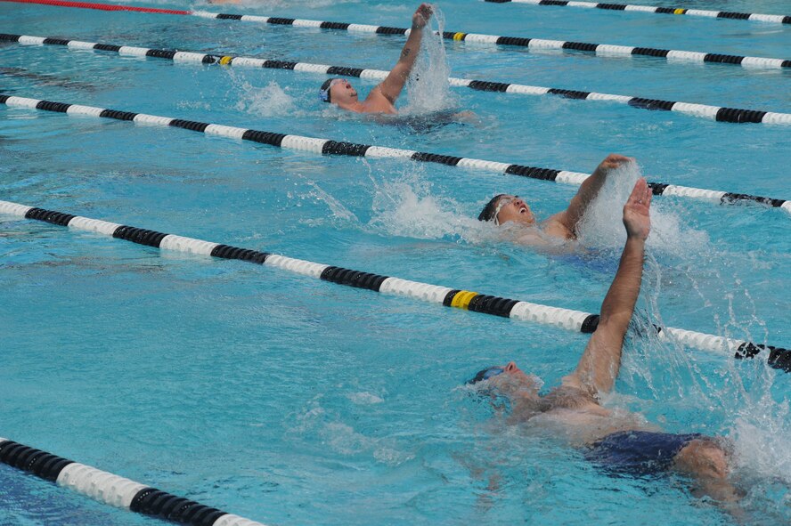 Air Force wounded warriors compete in a back-stroke event during the inaugural Wounded Warrior Pacific Invitational in Honolulu, Hawaii, Jan. 9, 2014.   The race is part of the adaptive athletic reconditioning program which helps wounded warriors build strength and endurance, while they draw inspiration from their teammates. All enrollees in Air Force Wounded Warriors program are encouraged to make athletics an essential part of their recovery, rehabilitation and rehabilitation plans. (U.S. Air Force photo/Master Sgt. Matthew McGovern)