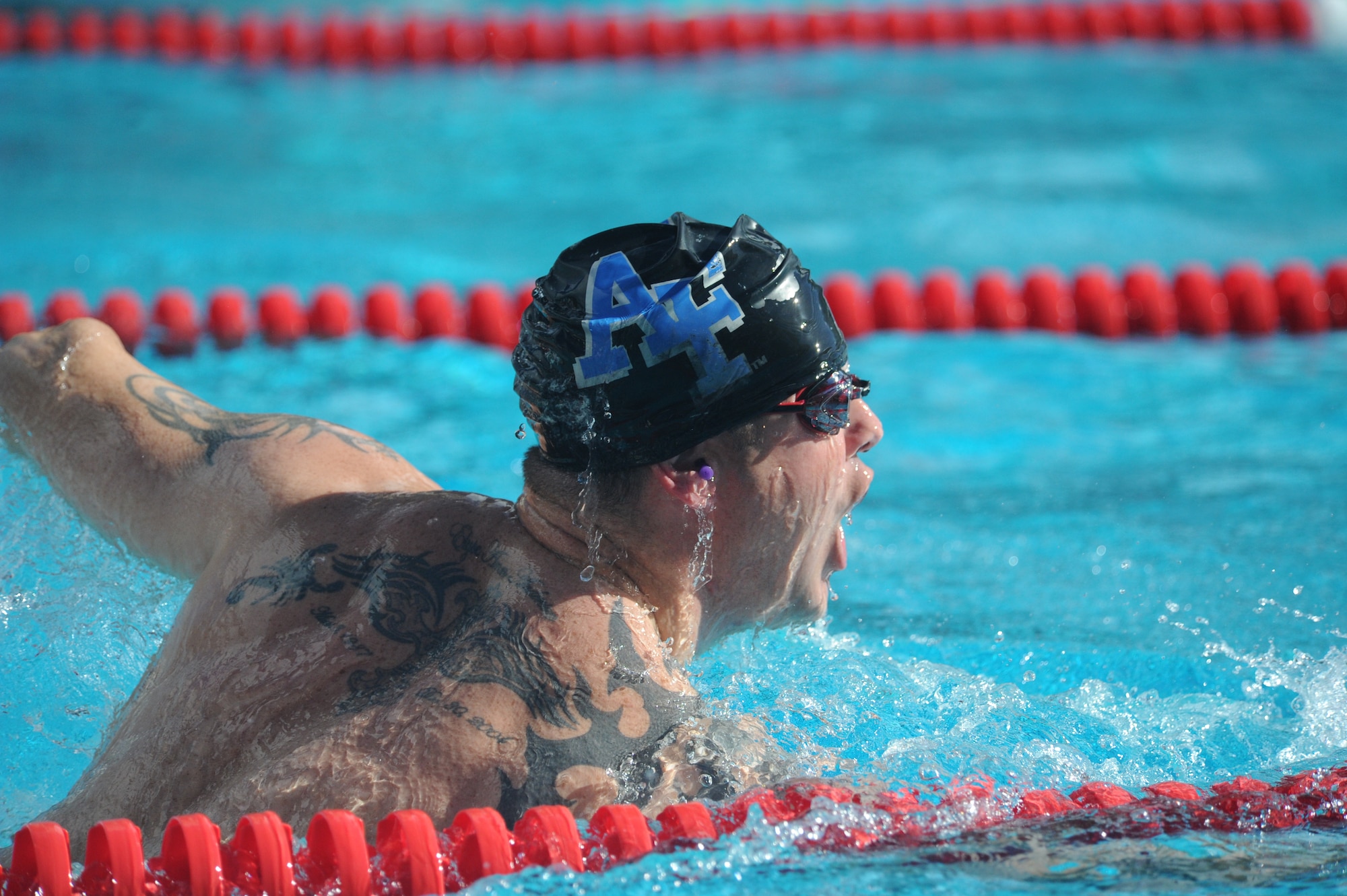 Tech. Sgt. Leonard Anderson, Air Force Wounded Warrior, competes in a swim meet during the inaugural Wounded Warrior Pacific Invitational in Honolulu, Hawaii, Jan. 9, 2014. Anderson was struck with an IED while on foot in Southwest Asia during a joint service mission with the Army. The goal of the Air Force Wounded Warrior Adaptive Sports program is to introduce adaptive sports early on in the healing process in order to promote physical, social, emotional and spiritual healing. (U.S. Air Force photo/Master Sgt. Matthew McGovern)