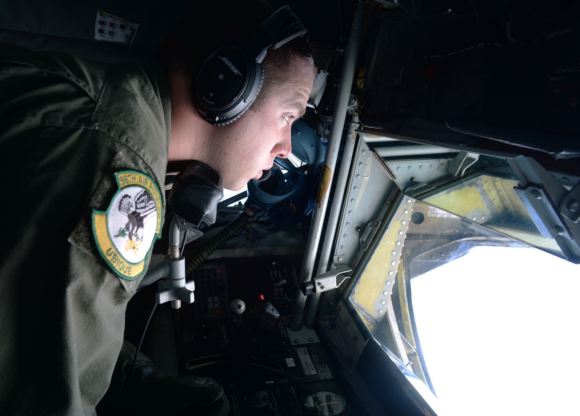 Senior Airman Keith Prochaska, 96th Air Refueling Squadron, controls the boom aboard a KC-135 Stratotanker while refueling an F-22 Raptor near Joint Base Pearl Harbor-Hickam, Hawaii, Jan. 10, 2014. Prochaska and his crew were participants in the Inaugural Total Force Integration Warrior Day, a training event that tested the cooperation and capabilities of multiple base agencies. The training highlighted the importance of integrating operations of active duty, Hawaii National Guard and Air Force Reserve units. (U.S. Air Force photo/Staff Sgt. Alexander Martinez)