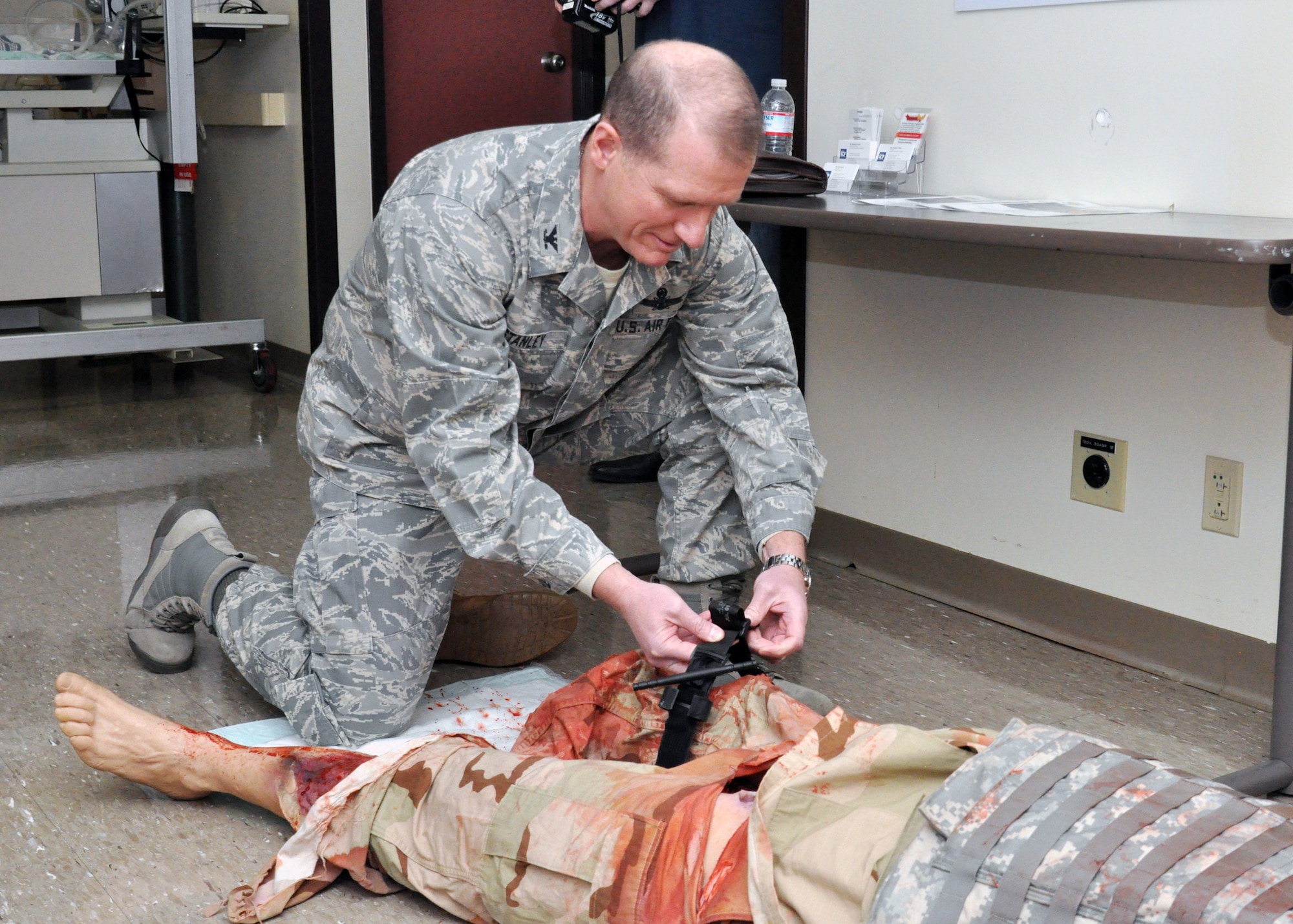 U.S. Air Force Col. Robert W. Stanley, 341st Missile Wing commander, applies a tourniquet to an interactive medical manikin Jan. 6, 2014, during his visit to David Grant Medical Center at Travis Air Force Base, Calif. (Air Force photo/Senior Airman Charles Rivezzo)