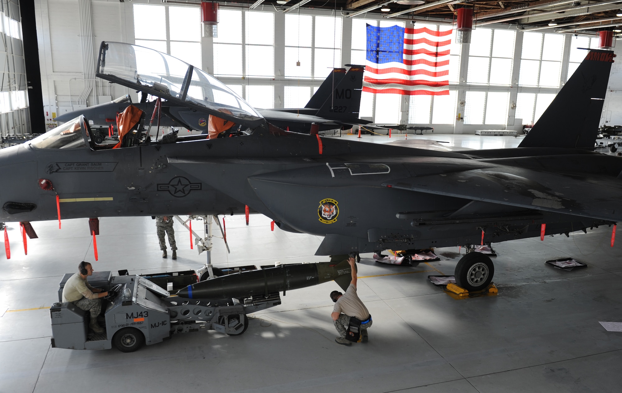 The 391st Fighter Squadron weapons load team loads an AIM-120 training munition onto an F-15E Strike Eagle during the annual Load Crew of the Year Competition at Mountain Home Air Force Base, Idaho, Jan. 7, 2013. Teams had to load one AIM-120, two GBU-12s and two MK-84 Airs to their respective jets within 50 minutes. Teams were graded and timed to see who would be the fastest and most precise weapons load crew. (U.S. Air Force photo by Airman 1st Class Brittany A. Chase/Released)