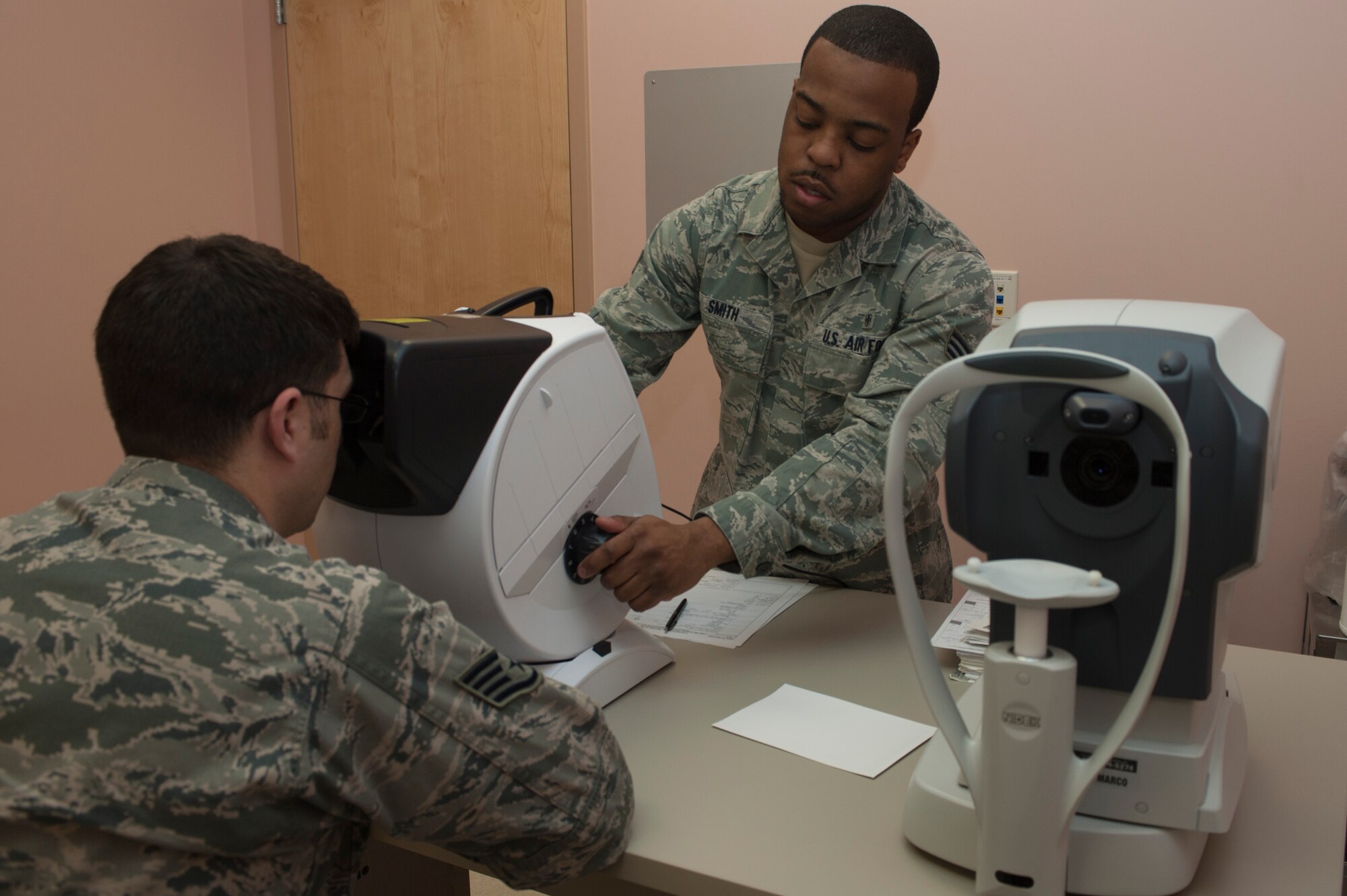 U.S. Air Force Senior Airman JaMicheal Smith, 99th Aerospace Medicine Squadron aerospace technician, conducts an eye exam on a patient Jan. 10, 2014, at Nellis Air Force Base, Nev. Regular eye exams are conducted to ensure work related sight problems can be quickly found and treated. (U.S. Air Force photo/Airman 1st Class Timothy Young)