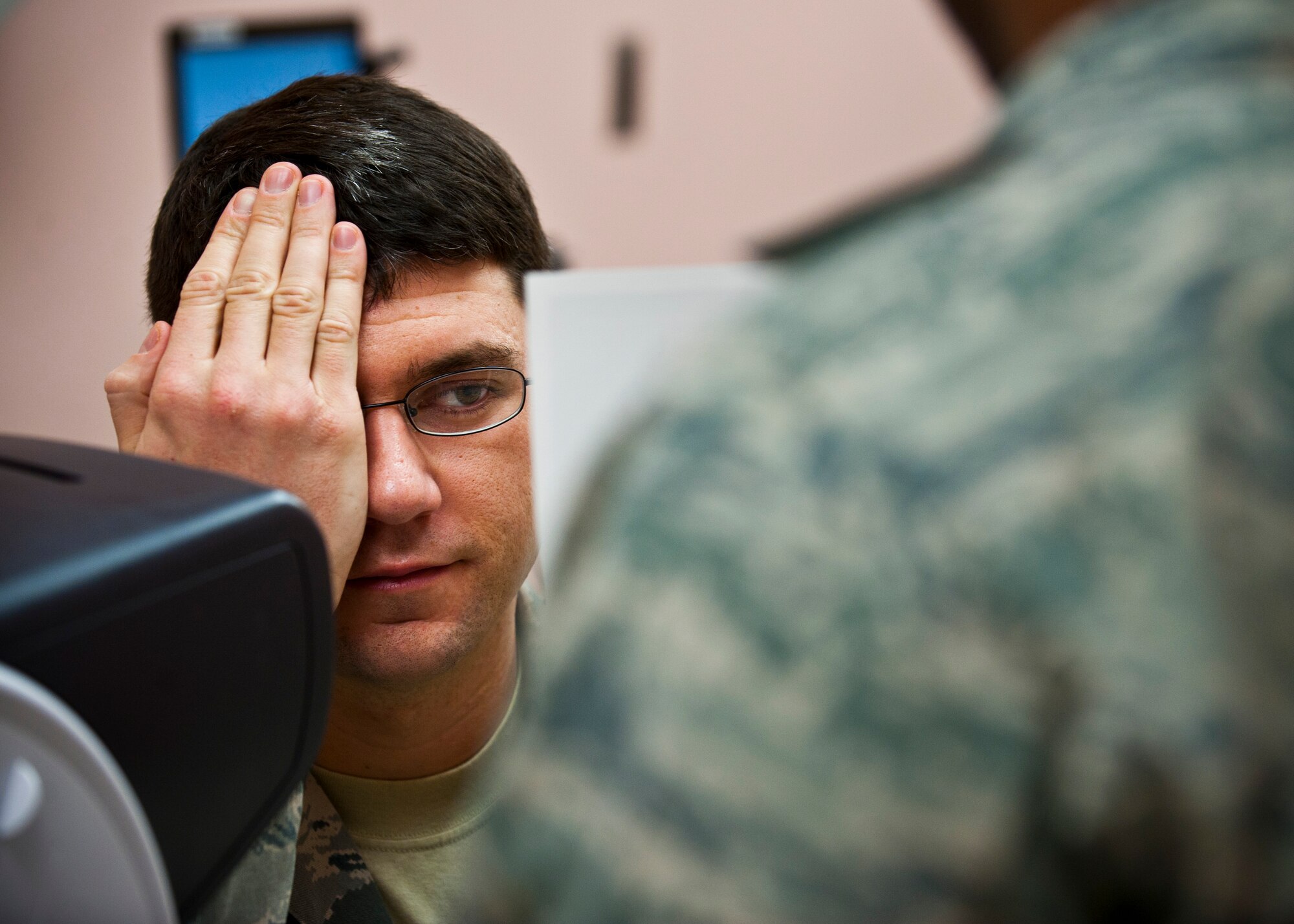 U.S. Air Force Staff Sgt. Shane Lahaie, 820th REDHORSE power production journeyman, receives an eye exam during an occupational health exam Jan. 10, 2014, at Nellis Air Force Base, Nev. An eye exam assesses vision and ability to focus on and discern objects. (U.S. Air Force photo/Senior Airman Brett Clashman)
