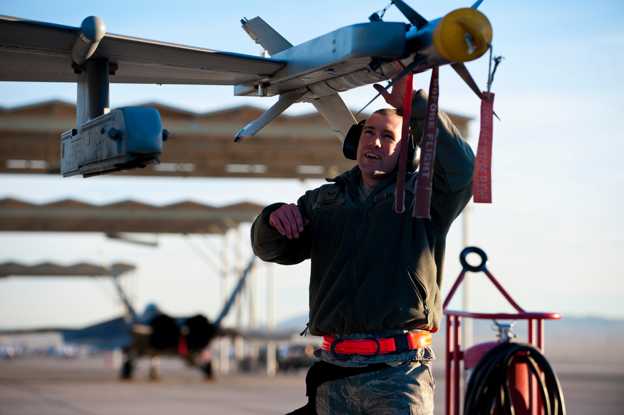 Senior Airman Jason Evans, 757th Aircraft Maintenance Squadron weapons load crew chief, inspects an inert AIM-9 sidewinder missile during a quarterly load crew competition, Jan. 10, 2014, at Nellis Air Force Base, Nev. Load crew competitions are held quarterly, in addition to a fifth competition to determine the load crew of the year. (U.S. Air Force photo by Airman 1st Class Thomas Spangler)