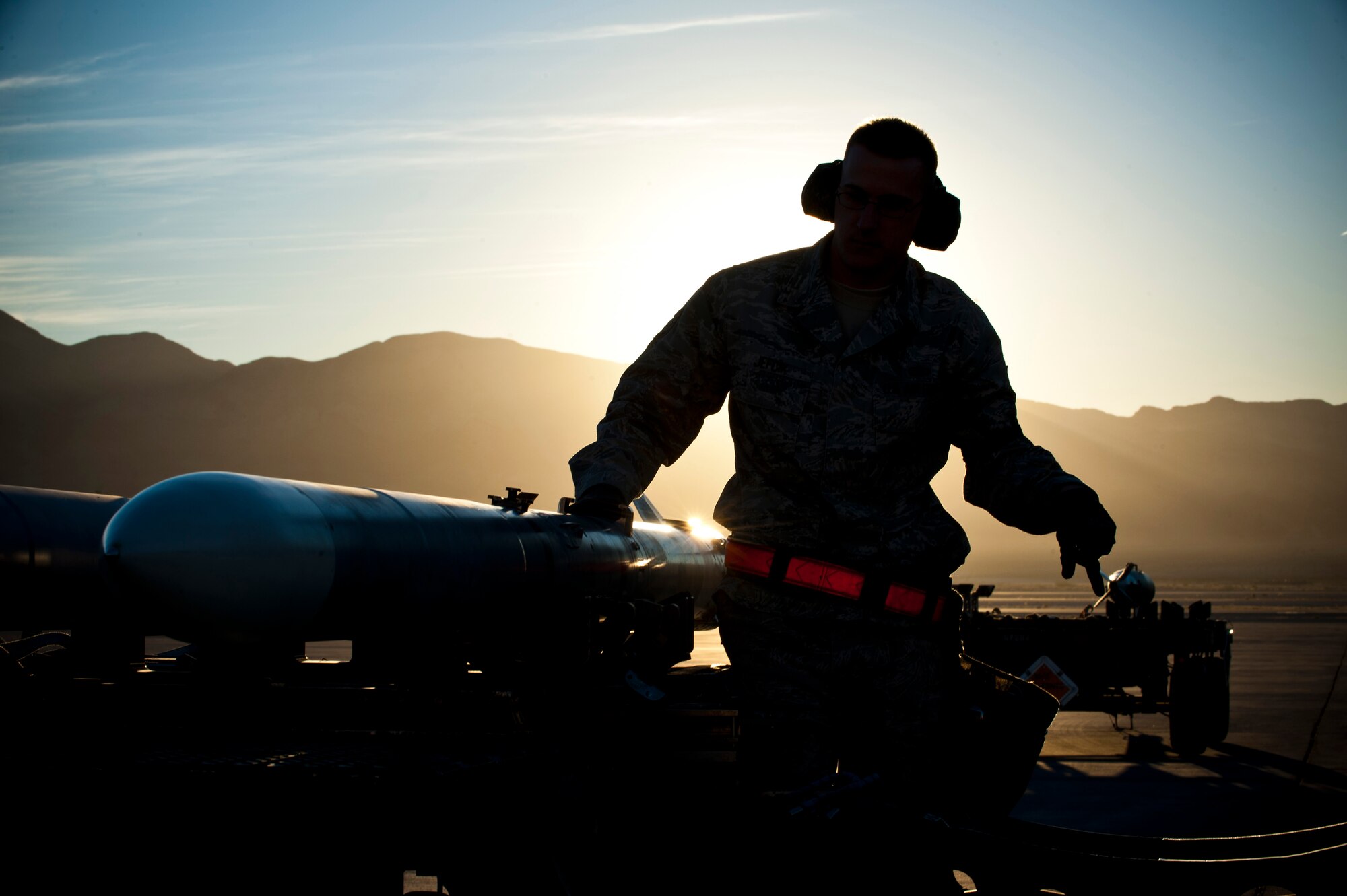 Staff Sgt. Ronald Jefcik, 757th Aircraft Maintenance Squadron weapons load crew chief, prepares to load inert munitions during a quarterly load crew competition, Jan. 10, 2014, at Nellis Air Force Base, Nev. Load crews compete with one another to maintain their skills and to promote camaraderie. (U.S. Air Force photo by Airman 1st Class Thomas Spangler)