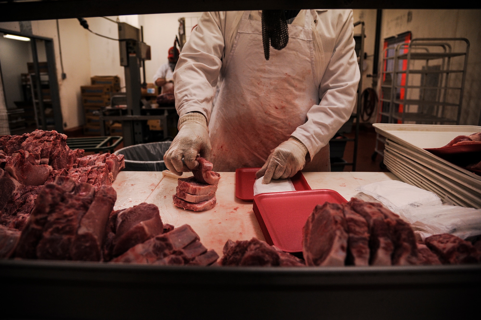 Sam Scott, Little Rock Air Force Base Commissary meat cutter, slices a piece of beef Nov. 11, 2013, at Little Rock Air Force Base, Ark. Thousands of pounds of meat are cut at the commissary on a weekly basis. (U.S. Air Force photo by Airman 1st Class Harry Brexel)