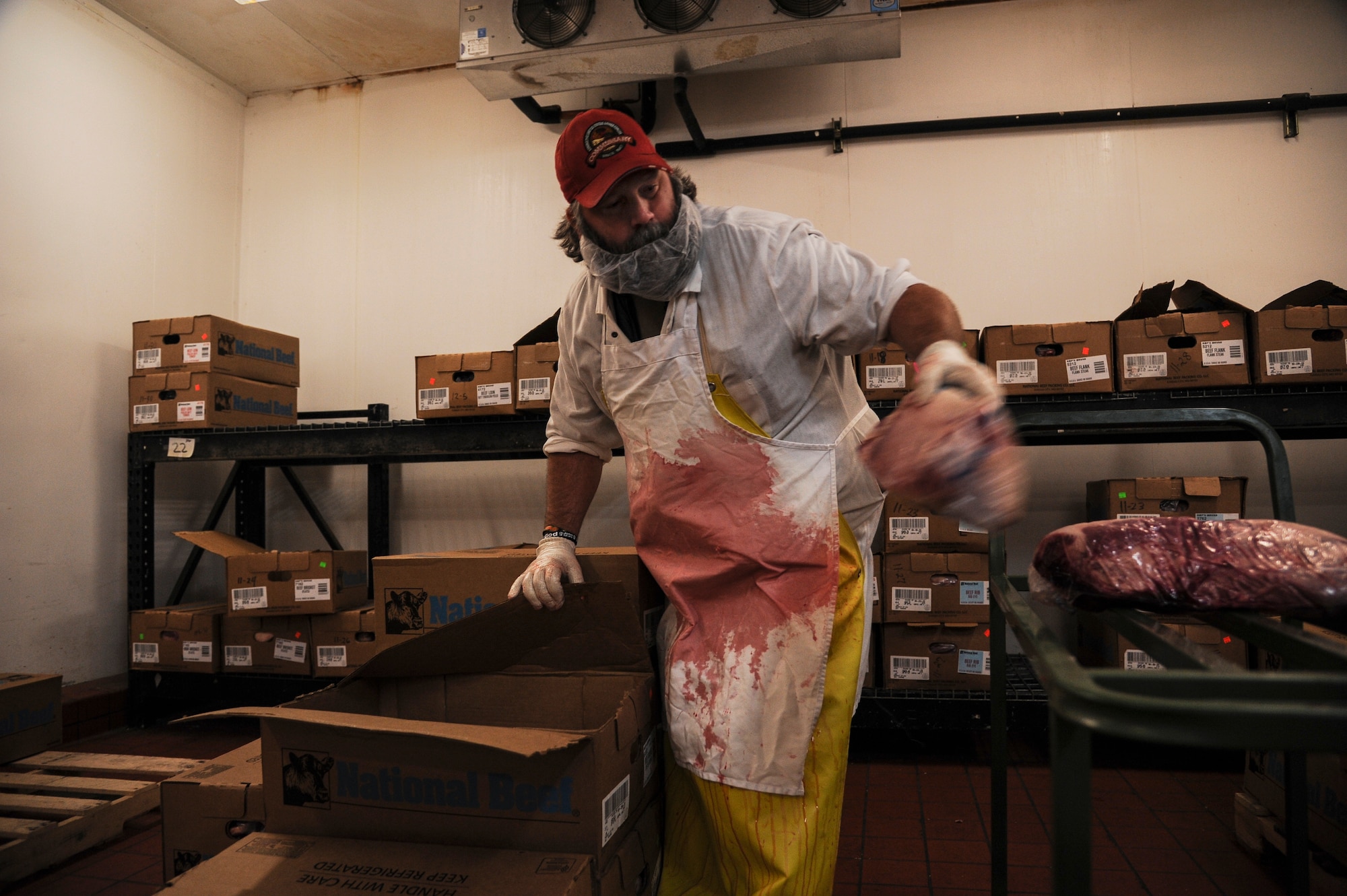 Bruce Nyhuis, Little Rock Air Force Base Commissary meat cutter, loads a cart with a recent shipment of beef Nov. 11, 2013, at Little Rock Air Force Base, Ark. The commissary receives at least two shipments of meat every week. (U.S. Air Force photo by Airman 1st Class Harry Brexel) 