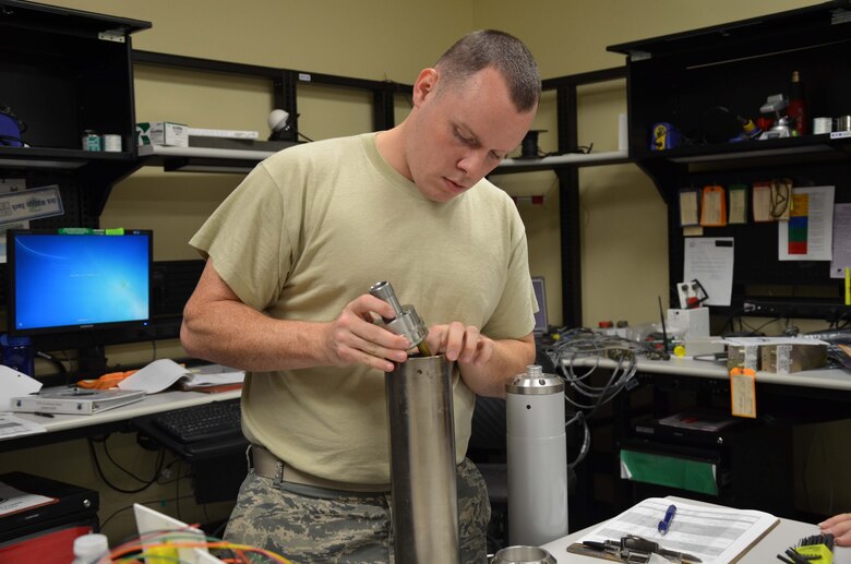 Staff Sgt. Tobee Jefferson, a geophysical maintenance supervisor with the Air Force Technical Applications Center, Patrick AFB, Fla., installs a high-grade, stainless steel instrument head into a 23900 seismometer.  (U.S. Air Force photo by Susan A. Romano)