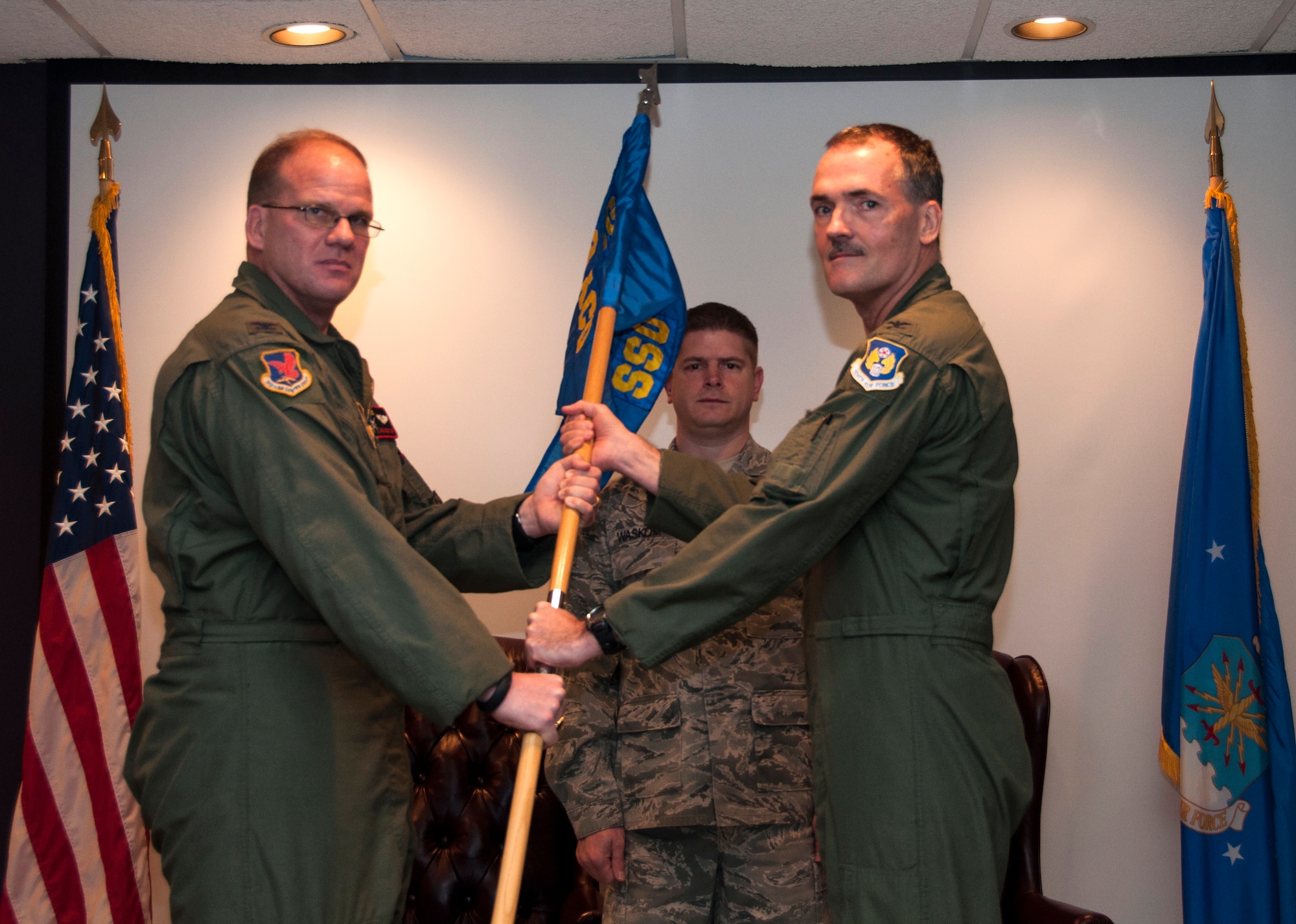 Colonel David Robertson, left, assumes command of the 513th Air Control Group from presiding officer, Col. William Lyons, assistant vice commander and chief of staff, 10th Air Force, Naval Air Station Fort Worth Joint Reserve Base, Texas, during a ceremony in the 970th Airborne Air Control Squadron auditorium Friday Jan. 10, 2014.  During the ceremony, Robertson laid out his top three priorities as new commander:  Air Force Core values, total force integration and family.  Former 513th ACG commander, Col. Jeffrey J. McGalliard currently serves as Commander, 445th Airlift Wing, Wright-Patterson AFB, Ohio.  (U.S. Air Force photo/Senior Airman Mark Hybers)