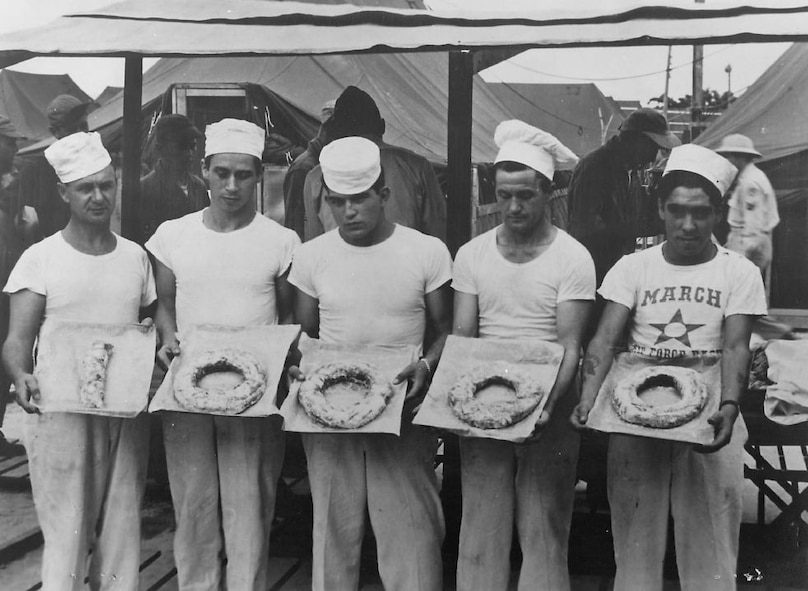 Bakers in the 22d Bomb Group make an appropriate and edible marker to signify the 10,000th doughnut made in Korea. (Strategic Air Command archives)