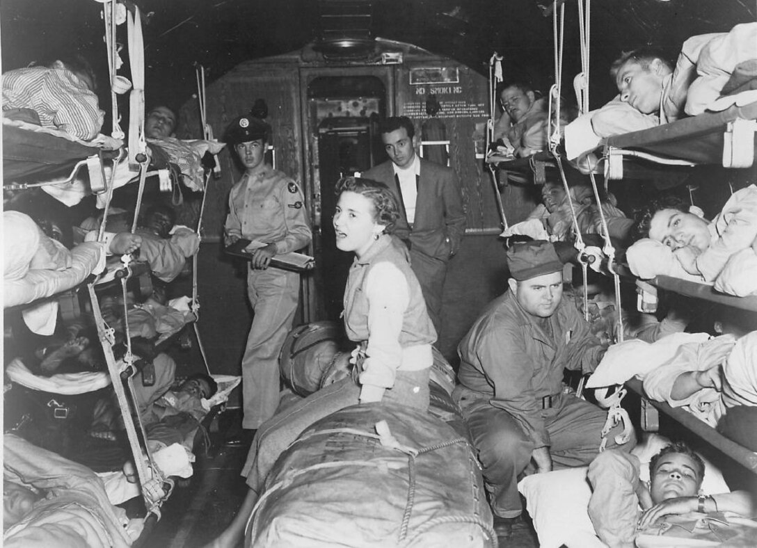 Fay Brown, Hollywood vocalist, sings for Korean War wounded aboard a MATS transport plane at Travis Air Force Base. October 7, 1950. (Strategic Air Command Archives)