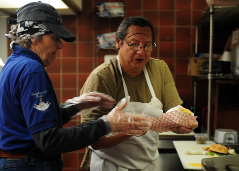 Barb Ainsworth, left, and Joe Valdez, both assigned to the 7th Force Support Squadron, prepare a meal Jan. 10, 2014, at Dyess Air Force Base, Texas. Dyess Lanes provides food specials daily. After being recognized as the best bowling program in Air Combat Command, they will now go on to compete at Air Force level. (U.S. Air Force photo by Senior Airman Kia Atkins/Released)