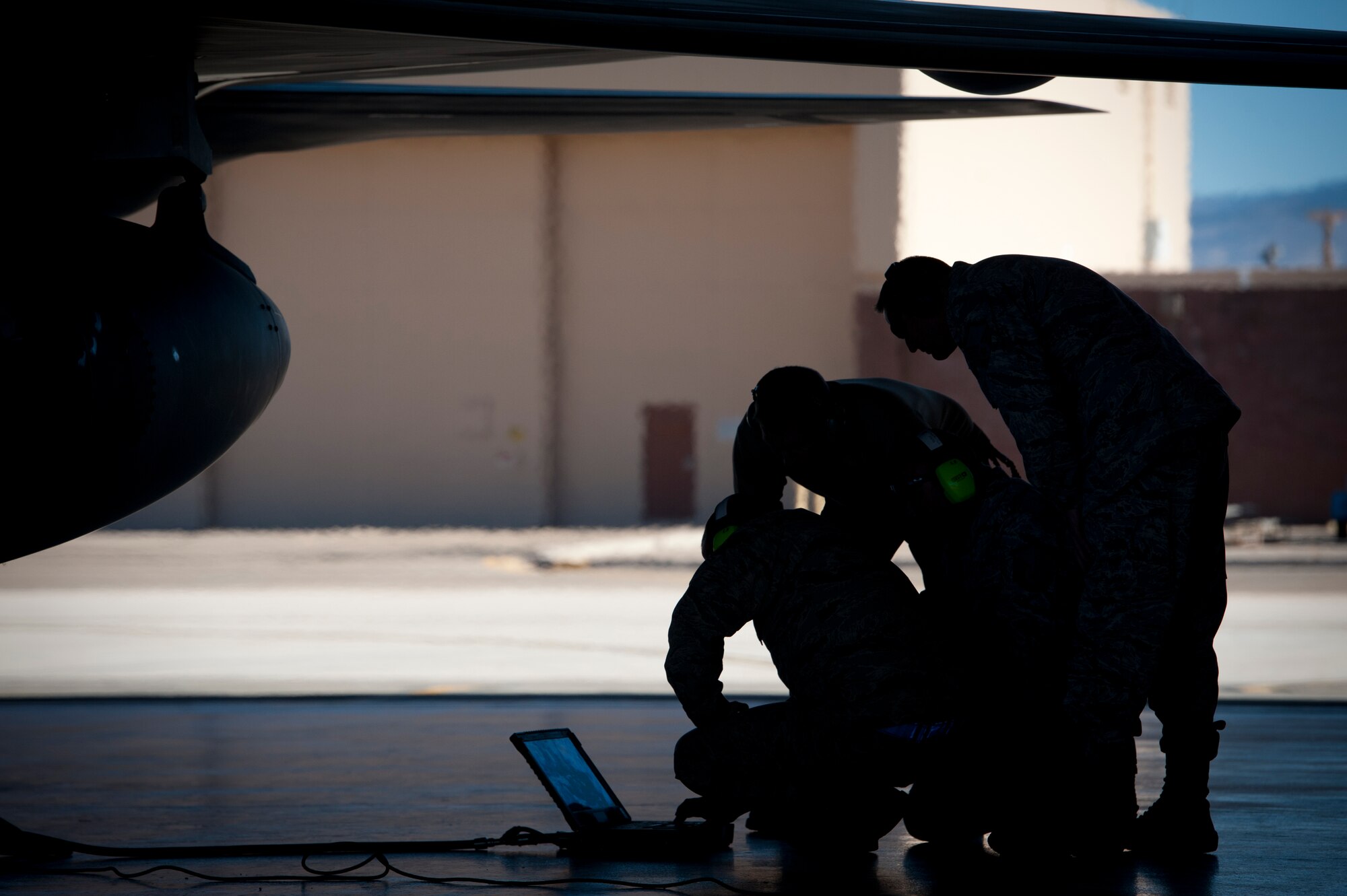 Airmen from the 49th Aircraft Maintenance Squadron perform pre-flight checks and preparations on an F-22 Raptor at Holloman Air Force Base, N.M., Jan. 6. The first five of 24 combat-deployable F-22 Raptors left Holloman heading to Tyndall Air Force Base, Fla. as a permanent change of station. The five F-22s that left Jan. 6 will be followed by six Raptors leaving each month until the move is completed. (U.S. Air Force photo by Airman 1st Class Aaron Montoya)